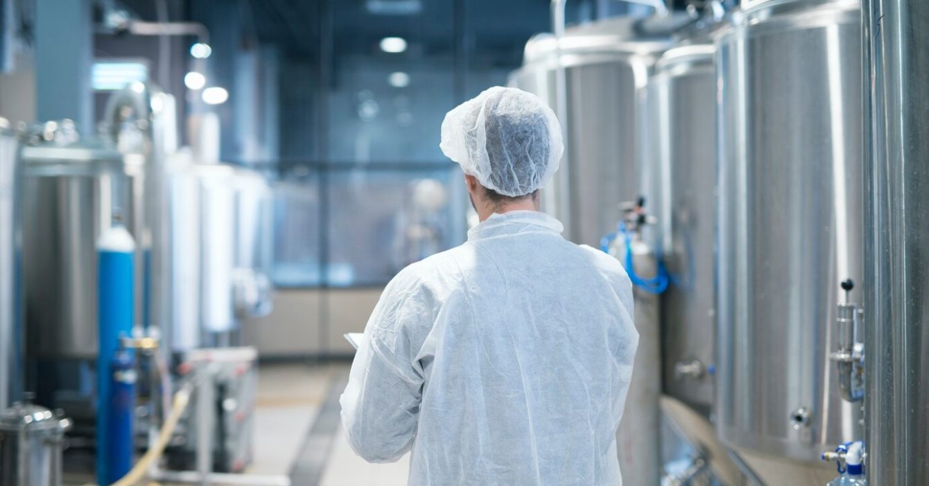 technologist-white-protective-suit-walking-through-food-factory-production-line-checking-quality_342744-1217 تجهیزات صنایع لبنیات
